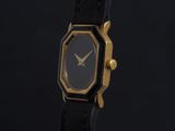 an image of a black and gold watch on a black background