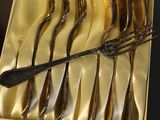 a box with a bunch of forks and spoons in it