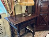 a table with a lamp on top of it in a room