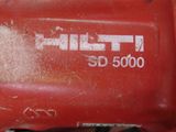 a close up of a red machine that is on a table