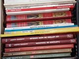 a basket full of books sitting on the floor