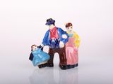 a figurine of a man and a woman sitting on a bench