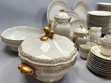 a lot of white and gold china dishes and cups
