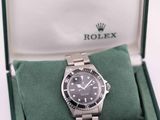 a rolex watch in a green box on a white surface