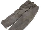 an old pair of pants sitting on top of a white surface