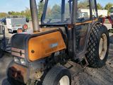 a tractor that is parked in the dirt