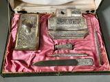 a box that has a set of silver items in it