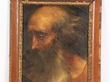 un vieux tableau représentant un homme à la longue barbe, dans un cadre en bois
