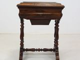 an old wooden table with a drawer on top of it
