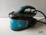 a black and blue steam iron sitting on a counter