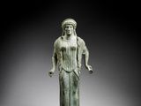an image of a statue of a woman in a green dress