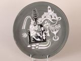 a black and white plate with a picture of a cat on it
