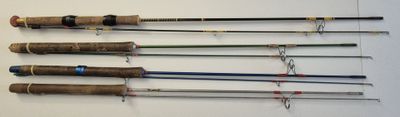 several fishing rods are lined up on a wall in a room