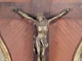 a statue of jesus on the cross on the wall