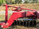 a red tractor with a plow attached to it