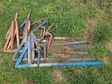 a pile of old rusty tools in the grass