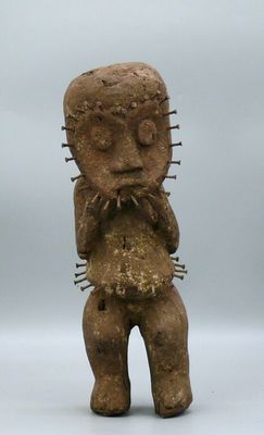 statue of a man holding a piece of wood in his right hand