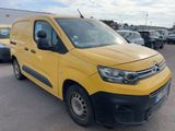 the yellow van is parked in a parking lot with other cars