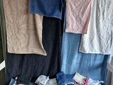 many towels hanging on a clothes rack in a room