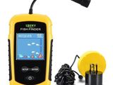 a close up of a yellow fish finder next to a charger