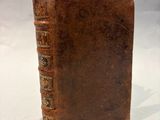 an old book with a piece of paper sticking out of it