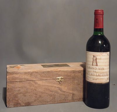 a bottle of wine sitting next to a wooden box