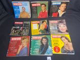 a lot of different magazine covers on a black surface