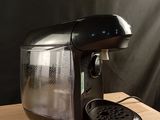 a coffee maker that is sitting on a wooden table