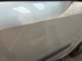 a car that has been dented and is parked on the side of the road