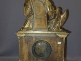 a statue of a woman sitting on top of a clock
