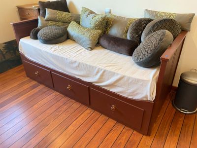 a couch with pillows and pillows on it in a living room