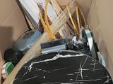 a toilet in a box with a black marble seat
