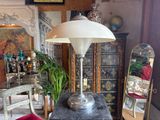 a table with a lamp on top of it in a room