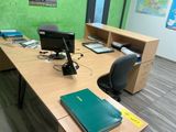a desk with a computer and a book on it