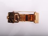 a close up of a gold bracelet with a chain around it