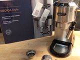 une cafetière posée sur une table à côté d'une boîte de café