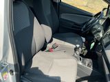 a silver car with a black seat cover and a black steering wheel