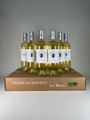 four bottles of white wine sitting on top of a cardboard box