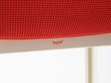 the back of a red speaker sitting on top of a window sill