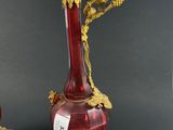 pair of red and gold vases sitting on top of a table