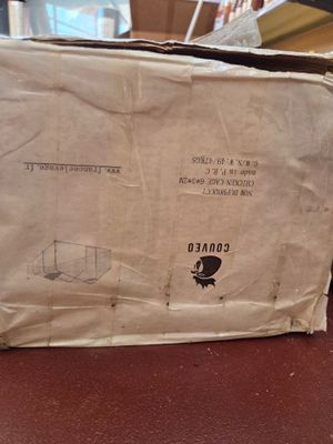 a box that is sitting on the floor next to a chair