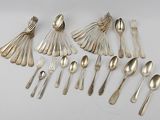 a lot of silver spoons and spoons on the table