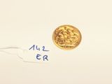 a small piece of paper that has a gold coin on it