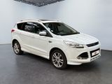 the white ford kuga is parked in a large room