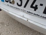 a close up of a license plate on a white car