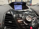 a car dashboard with a digital display in the center
