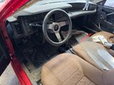 a red car with a steering wheel and a dashboard