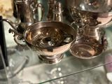 a glass shelf with silver objects on it