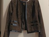 jacket hanging on a hanger on a wall in a room