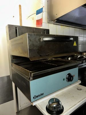 a stove that is sitting in a kitchen next to a stove top